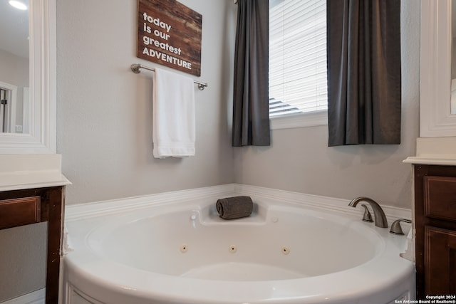 bathroom featuring vanity and a bath