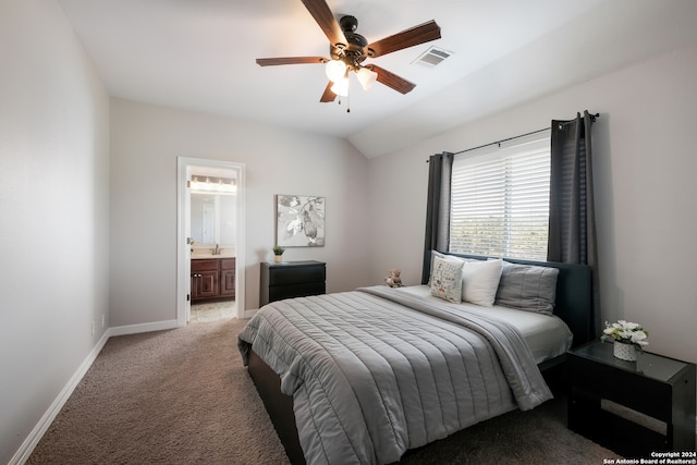 carpeted bedroom featuring connected bathroom, sink, vaulted ceiling, and ceiling fan