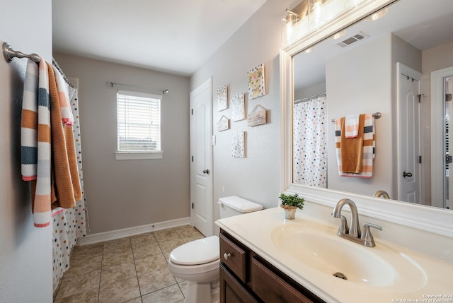 bathroom featuring tile patterned flooring, curtained shower, vanity, and toilet