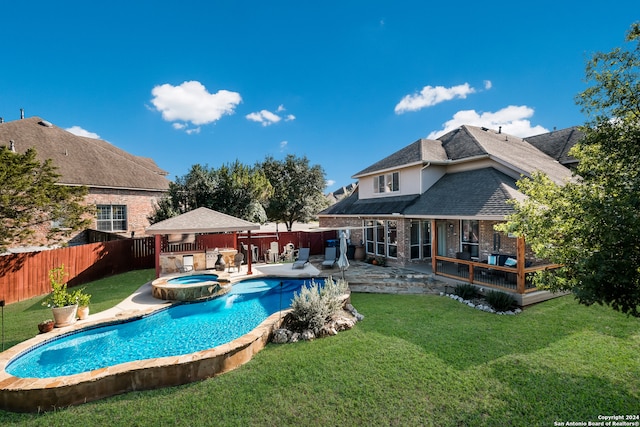 view of pool with a patio area, a yard, and an in ground hot tub