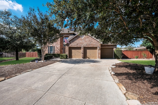 view of front of home with a front yard and a garage