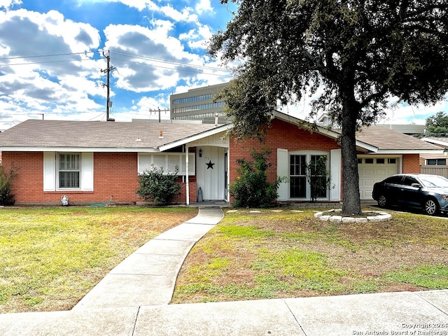 single story home with a garage and a front yard