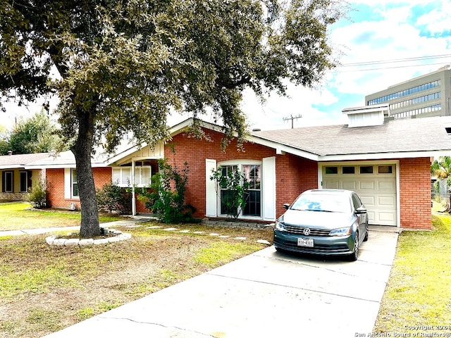 ranch-style house with a garage and a front lawn