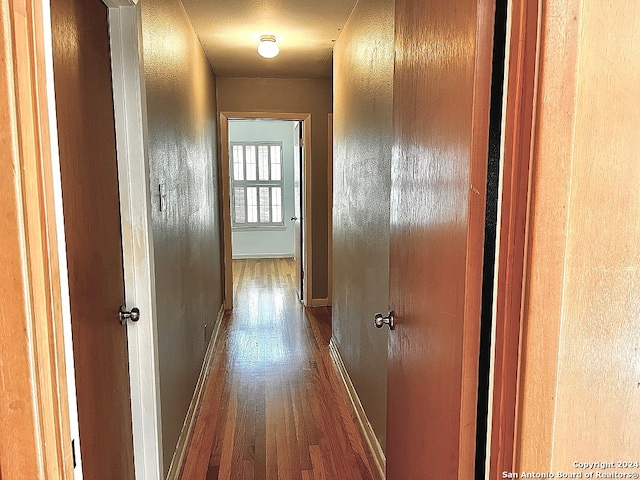 hallway with wood-type flooring