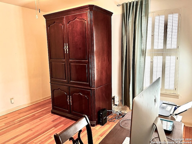 office with light hardwood / wood-style floors