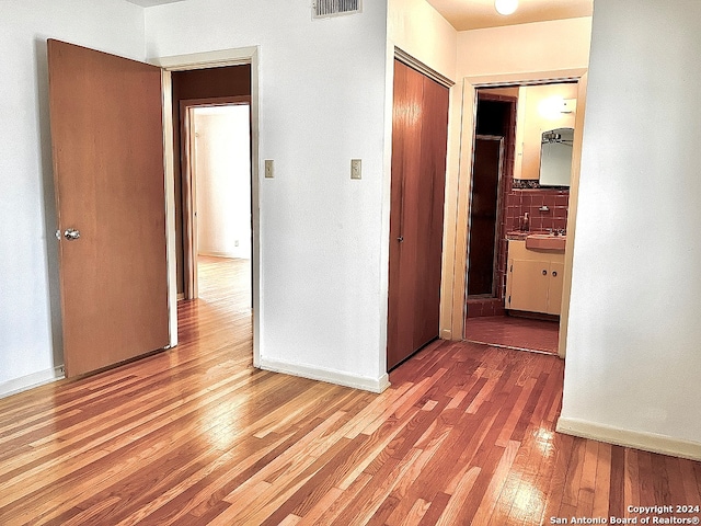 hallway featuring sink and hardwood / wood-style flooring