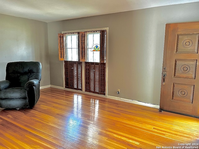 foyer entrance with hardwood / wood-style flooring and a textured ceiling