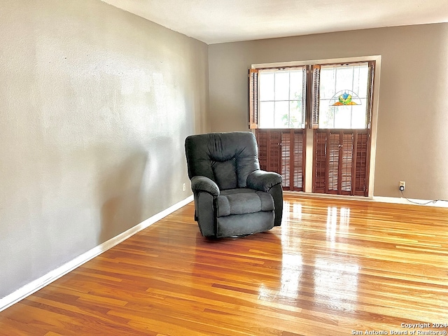 living area with hardwood / wood-style flooring