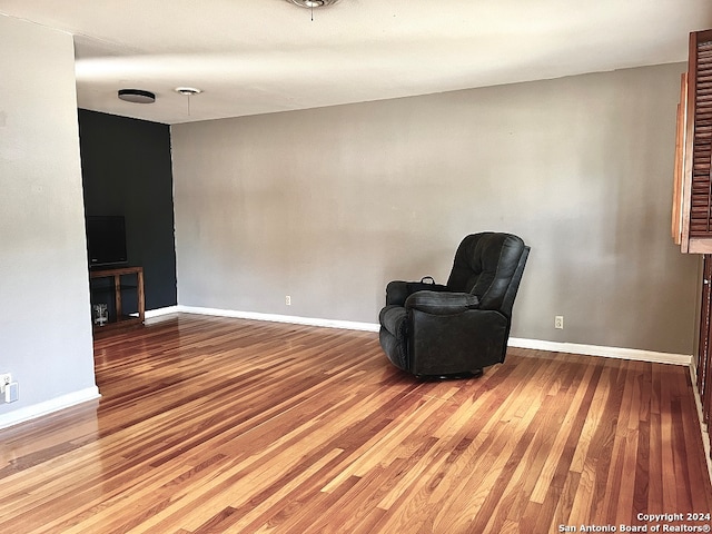 unfurnished room with wood-type flooring