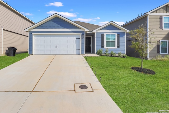 view of front of house featuring a front lawn and a garage