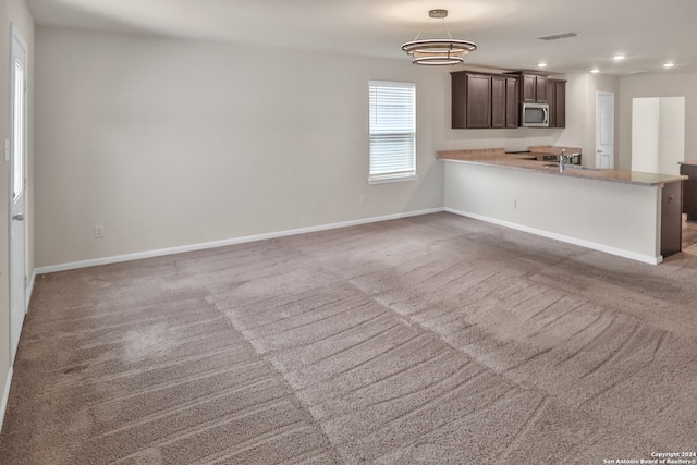 unfurnished living room featuring carpet floors