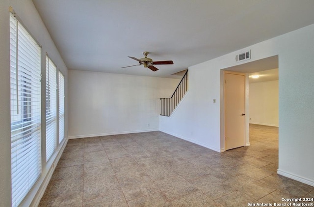 6810 Crown Rdg, San Antonio, TX 78239 - empty room featuring ceiling fan, baseboards, and stairway