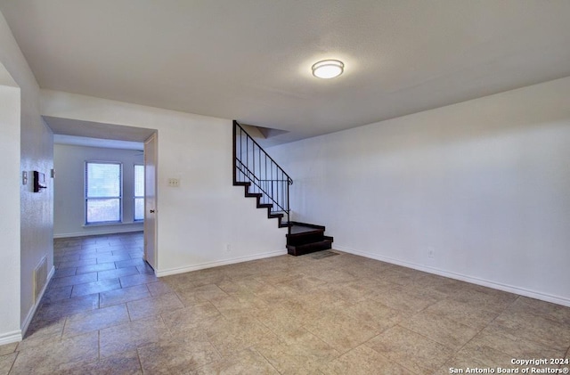 6810 Crown Rdg, San Antonio, TX 78239 - unfurnished living room with baseboards and stairway
