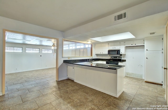 kitchen featuring white cabinets, stainless steel appliances, kitchen peninsula, and sink