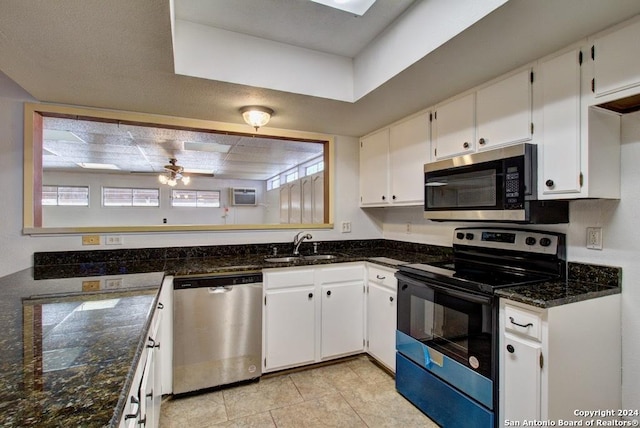 6810 Crown Rdg, San Antonio, TX 78239 - kitchen with appliances with stainless steel finishes, white cabinets, a sink, dark stone countertops, and ceiling fan