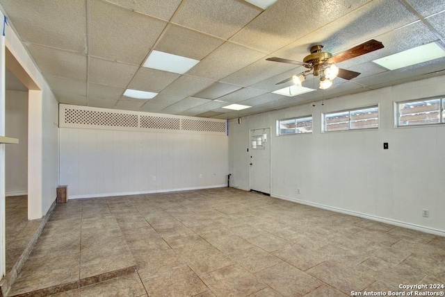 6810 Crown Rdg, San Antonio, TX 78239 - spare room with healthy amount of natural light, ceiling fan, baseboards, and wooden walls