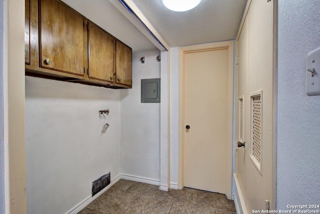 6810 Crown Rdg, San Antonio, TX 78239 - washroom with cabinet space, electric panel, baseboards, and a textured ceiling