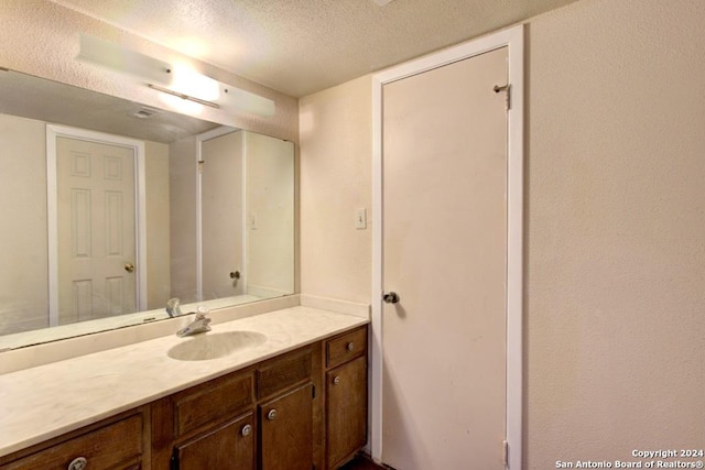 6810 Crown Rdg, San Antonio, TX 78239 - bathroom with a textured ceiling and vanity