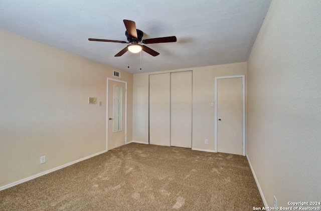 unfurnished bedroom featuring ceiling fan, a closet, and carpet floors