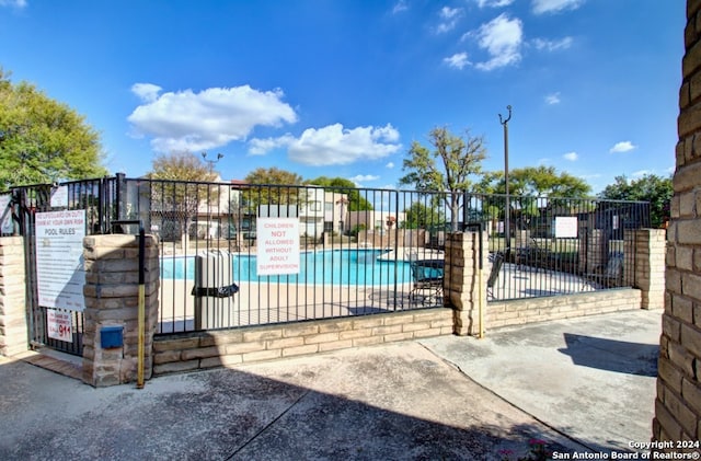 view of swimming pool with a patio