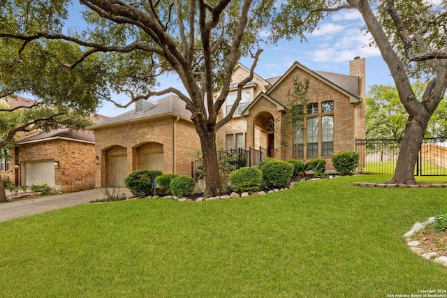 view of front facade featuring a front yard and a garage