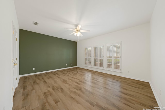 spare room with light hardwood / wood-style floors and ceiling fan