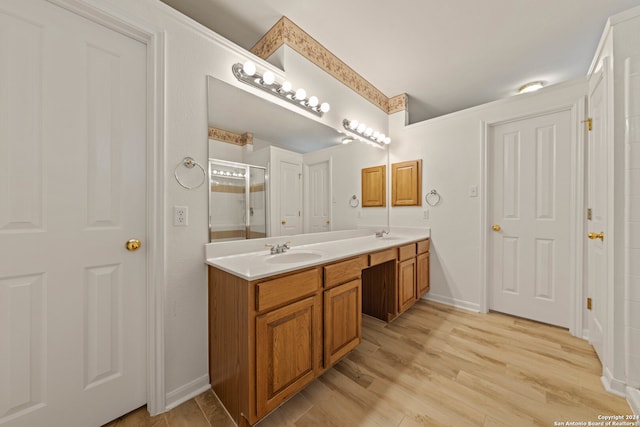 bathroom featuring vanity, a shower with shower door, and wood-type flooring