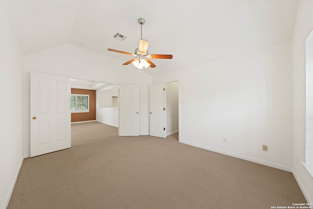 unfurnished room featuring ceiling fan, lofted ceiling, and light carpet