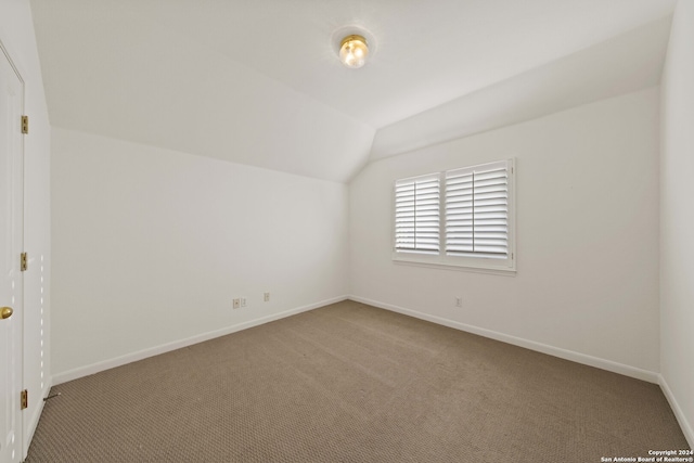 bonus room featuring carpet flooring and vaulted ceiling