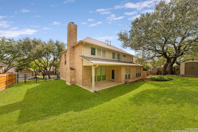 back of property featuring a patio, a storage unit, and a lawn