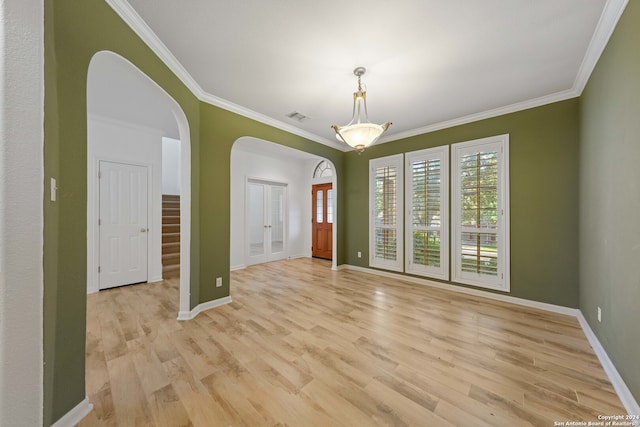 unfurnished room featuring light hardwood / wood-style flooring, french doors, and ornamental molding