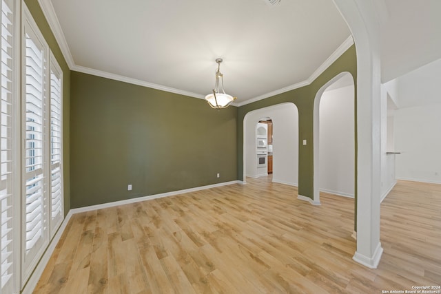 unfurnished room featuring light hardwood / wood-style floors, plenty of natural light, and crown molding