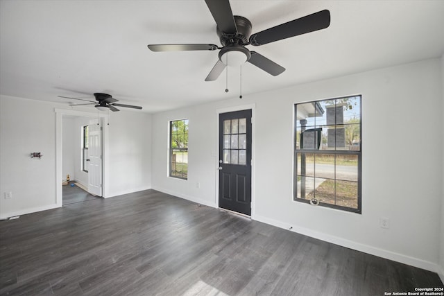 interior space with plenty of natural light, dark wood-type flooring, and ceiling fan