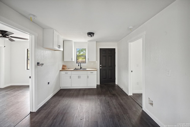 kitchen with dark hardwood / wood-style floors, white cabinetry, ceiling fan, and sink