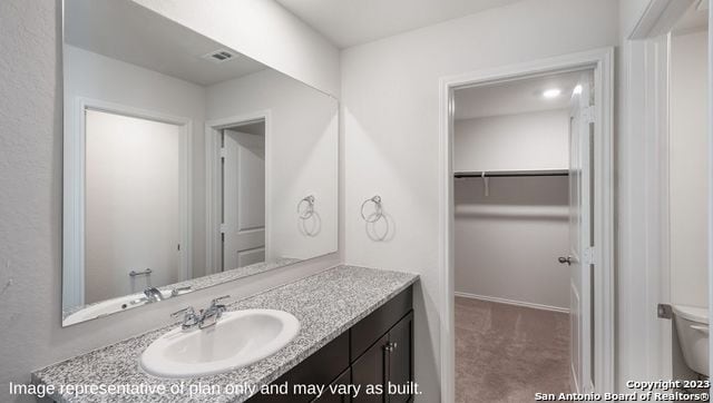 bathroom with vanity and toilet