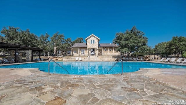 view of swimming pool featuring a patio area