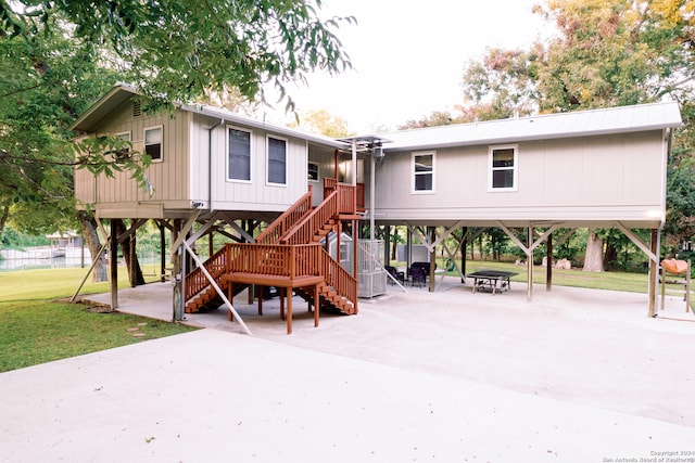 view of play area with a patio area and a fire pit