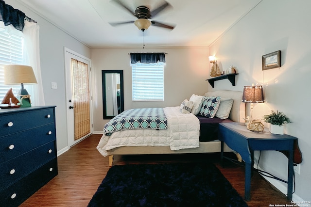 bedroom featuring access to outside, dark hardwood / wood-style floors, ceiling fan, and crown molding