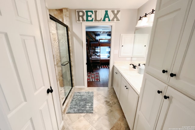 bathroom featuring vanity, wood-type flooring, and an enclosed shower