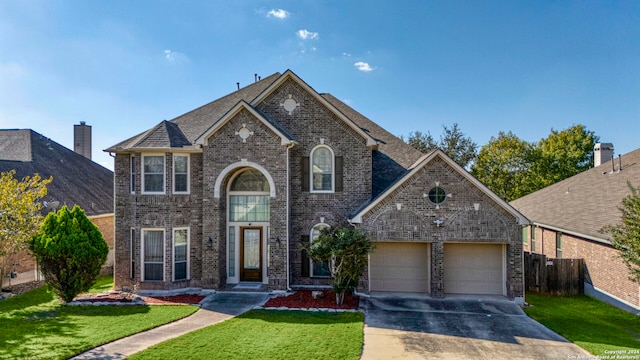 front of property featuring a front yard and a garage