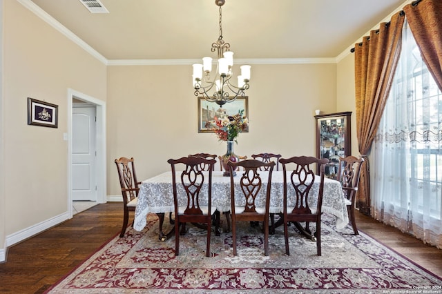 dining area with ornamental molding, dark wood-type flooring, and a notable chandelier