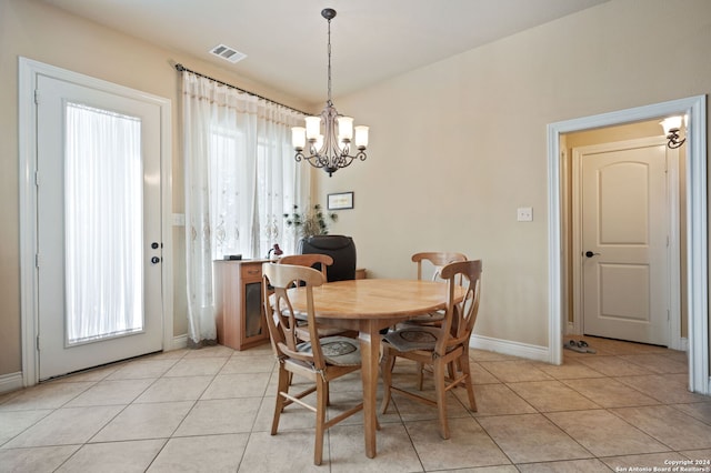 dining room with a notable chandelier and light tile patterned floors