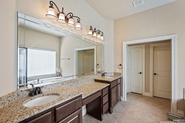 bathroom with vanity, tile patterned floors, and a bathtub