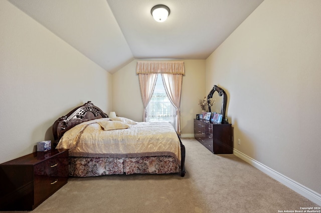 bedroom with lofted ceiling and carpet flooring