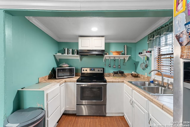 kitchen featuring stainless steel appliances, tile counters, ornamental molding, and sink