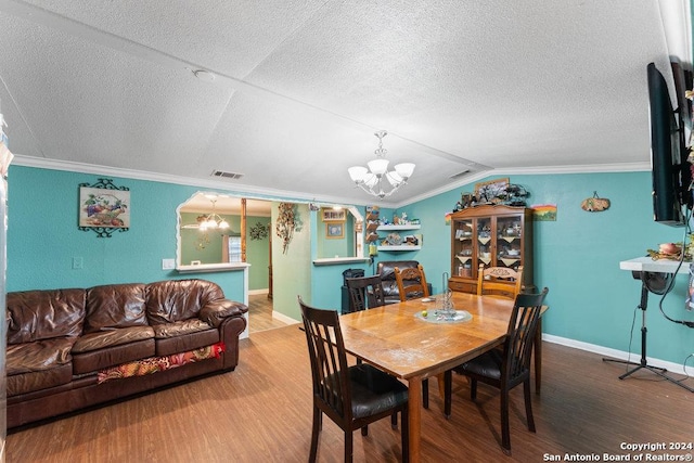 22620 Little Walnut Dr, San Antonio, TX 78264 - dining area with a chandelier, wood finished floors, vaulted ceiling, ornamental molding, and baseboards