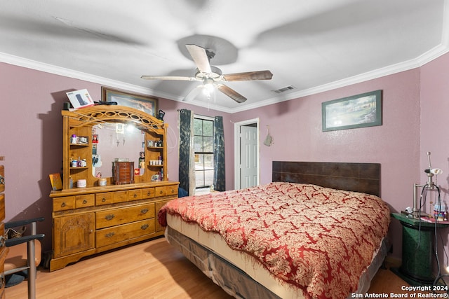 bedroom with light wood-type flooring, ceiling fan, and crown molding