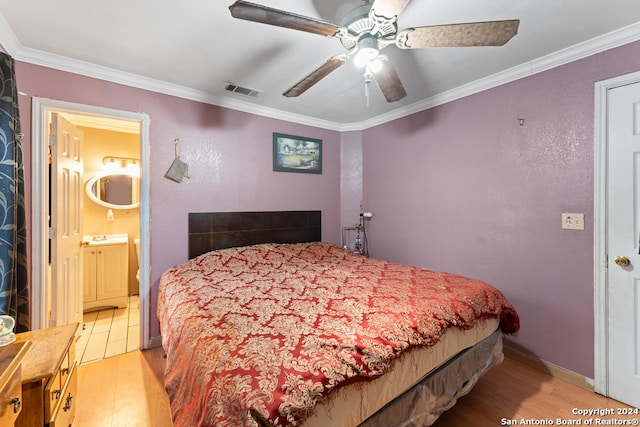 bedroom with light wood-type flooring, ensuite bath, ceiling fan, and crown molding