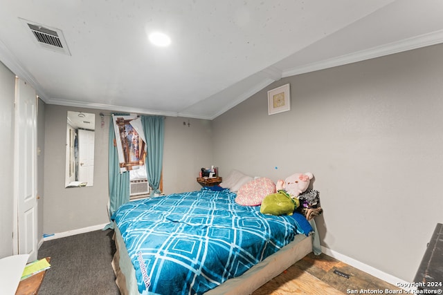 carpeted bedroom featuring vaulted ceiling and crown molding