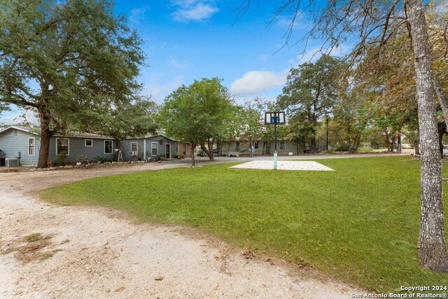 22620 Little Walnut Dr, San Antonio, TX 78264 - view of grassy yard featuring central AC